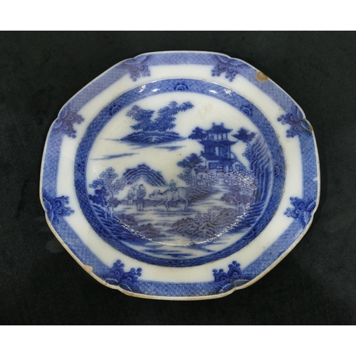 67 - An octagonal blue and white plate, depicting Oriental figures on riverbank with animal (chipped), 25... 