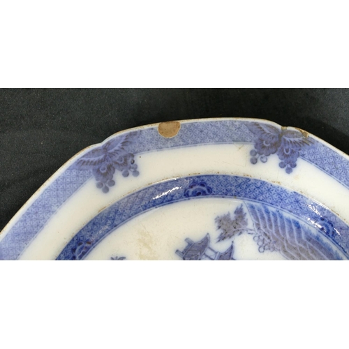 67 - An octagonal blue and white plate, depicting Oriental figures on riverbank with animal (chipped), 25... 