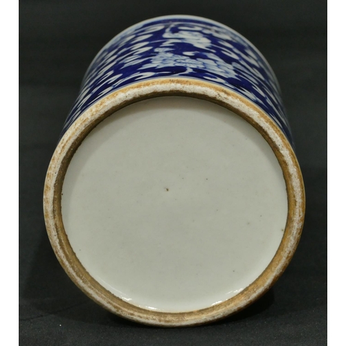 69 - An Oriental cylindrical brush pot on blue and white ground with figure, scroll and leaf decoration, ... 