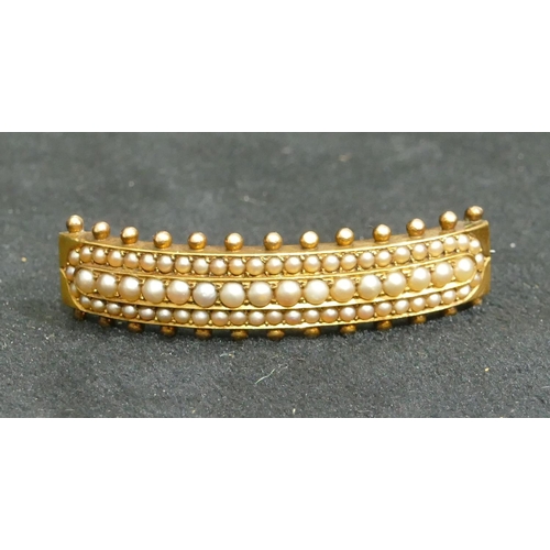 692 - A 15ct gold arched hair slide mounted with see pearls, 5cm long, 9.4 grams gross