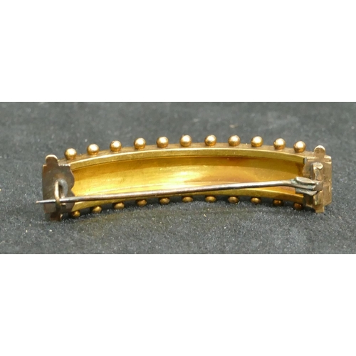 692 - A 15ct gold arched hair slide mounted with see pearls, 5cm long, 9.4 grams gross