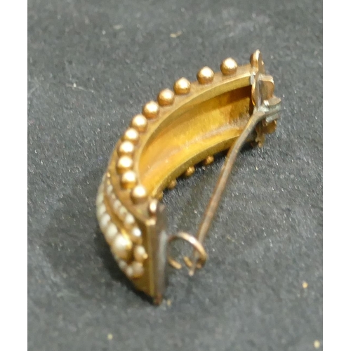 692 - A 15ct gold arched hair slide mounted with see pearls, 5cm long, 9.4 grams gross