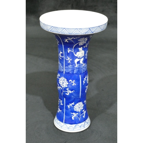 70 - An Oriental round bulbous trumpet shaped vase on blue and white ground with figure, floral and scrol... 