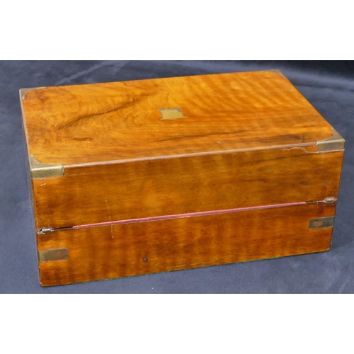 702 - A 19th Century walnut rectangular shaped writing box with brass mounts, hinged lid enclosing red lea... 