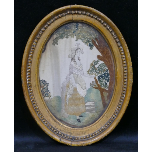 709 - A small 19th Century oval needlework hanging depicting milk maid standing under tree, in gilt frame ... 