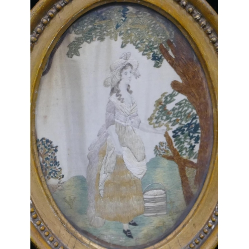 709 - A small 19th Century oval needlework hanging depicting milk maid standing under tree, in gilt frame ... 