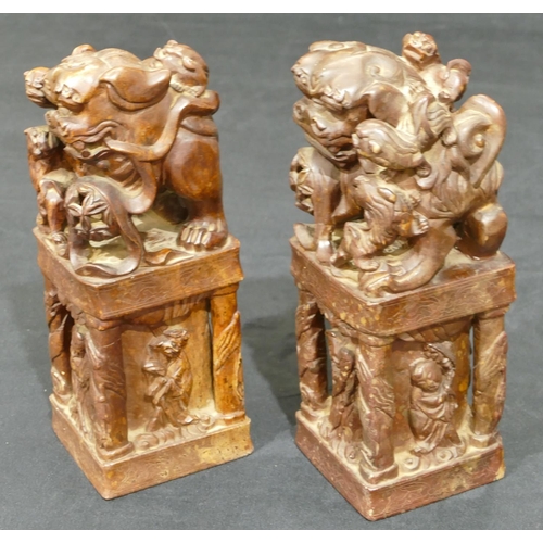 712 - A pair of Oriental hardstone large seals depicting dogs of fo standing upon square plinths with rais... 