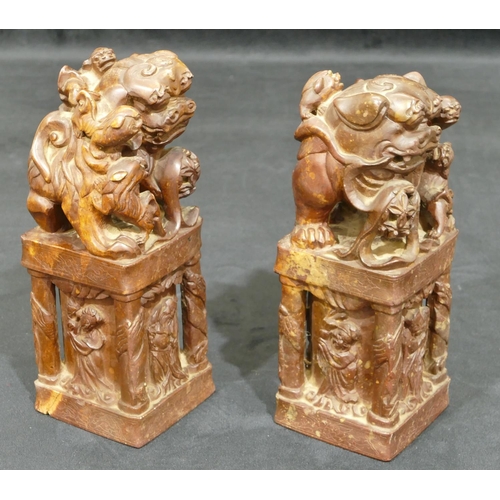 712 - A pair of Oriental hardstone large seals depicting dogs of fo standing upon square plinths with rais... 