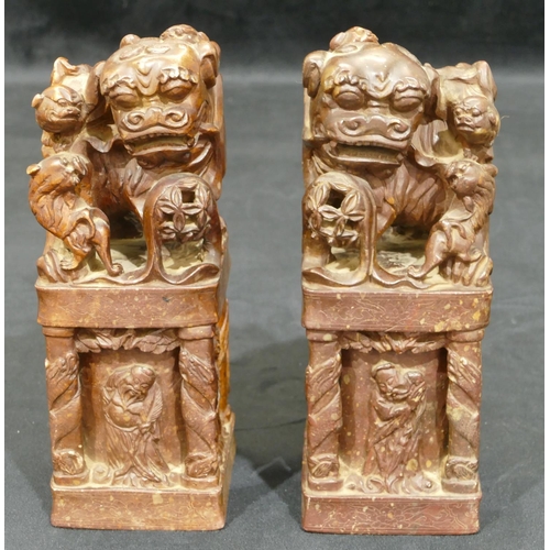 712 - A pair of Oriental hardstone large seals depicting dogs of fo standing upon square plinths with rais... 