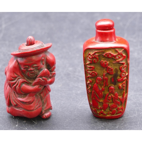 729 - An Oriental red snuff bottle with stopper, raised figure decoration 7cm high, a similar snuff bottle... 