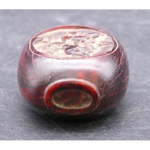 730 - An Oriental snuff bottle on red ground with oval panels depicting birds with stopper, 8.5cm high