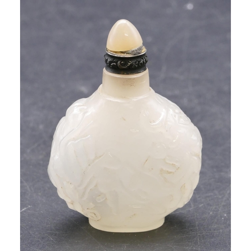 731 - An Oriental hardstone round bulbous shaped bottle with raised figure and scroll decoration with stop... 