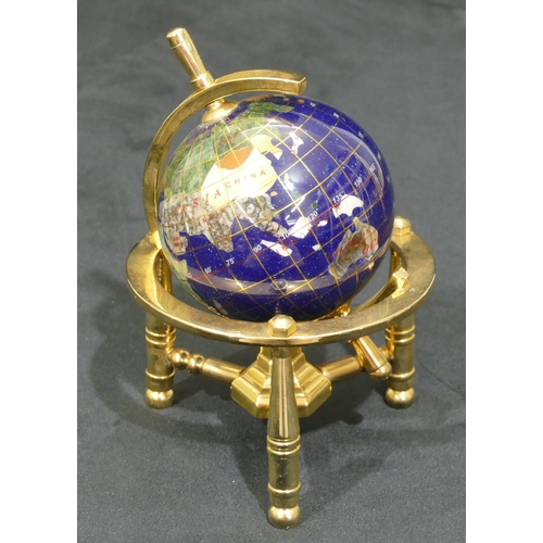 732 - A miniature gilt metal table top globe on turned leg, 15.5cm high