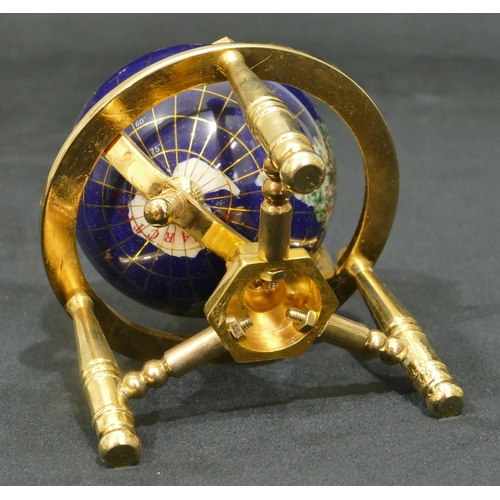 732 - A miniature gilt metal table top globe on turned leg, 15.5cm high