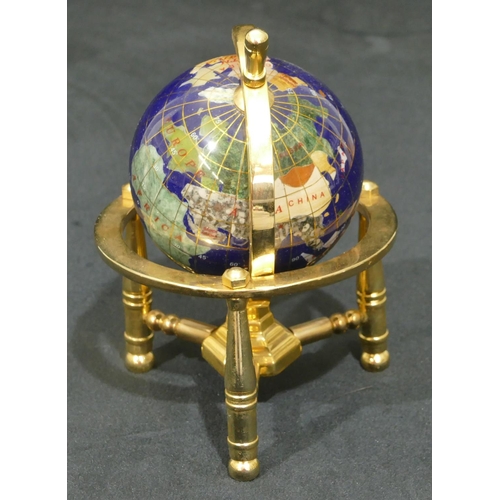 732 - A miniature gilt metal table top globe on turned leg, 15.5cm high