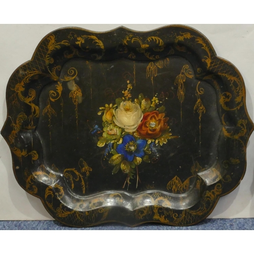 733 - A black lacquered papier mache rectangular scallop shaped tray with hand painted floral, leaf and gi... 