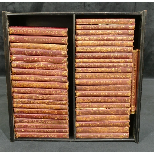 738 - A collection of red leather bound Shakespeare books, all mounted in ebonised table top cabinet