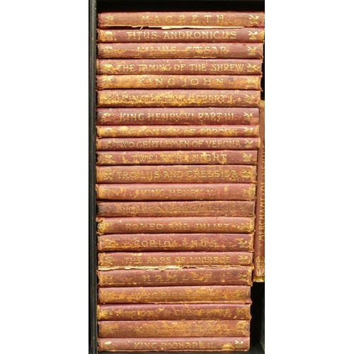 738 - A collection of red leather bound Shakespeare books, all mounted in ebonised table top cabinet