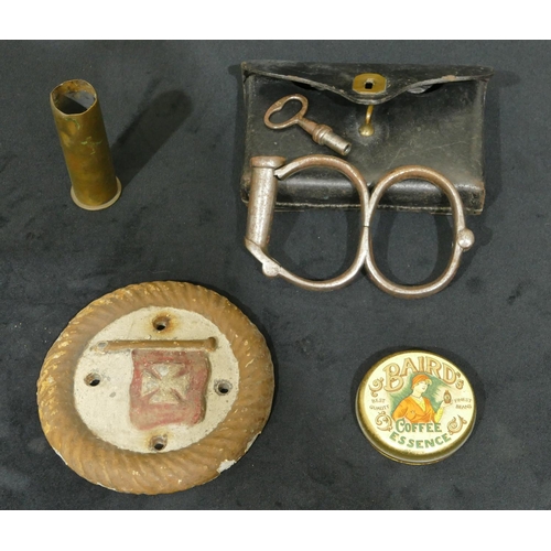 763 - A pair of W Cowen 19th Century handcuffs with key in fitted leather case, a metal circular plaque an... 