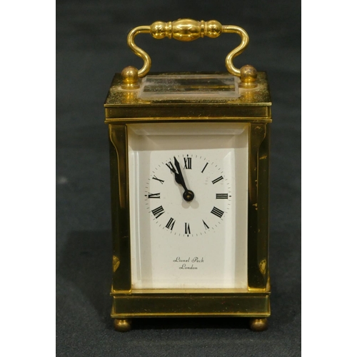 811 - Lionel Peck, London miniature brass carriage clock with white enamel dial, Roman numerals, swing ove... 