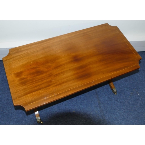 819 - A mahogany rectangular shaped coffee table with concaved reeded corners, inlaid stringing on lyre en... 