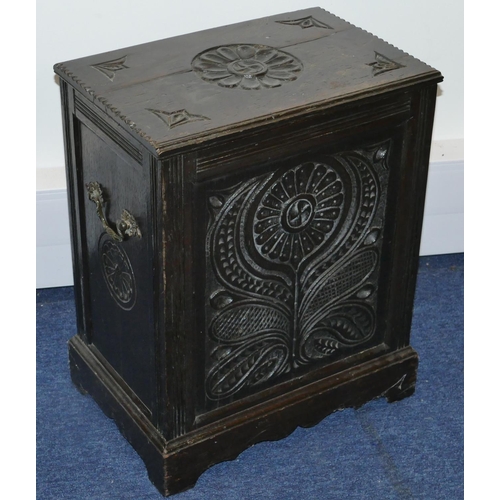 820 - A carved oak coal box with hinged lid with floral and leaf decoration, enclosing liner on bracket fe... 