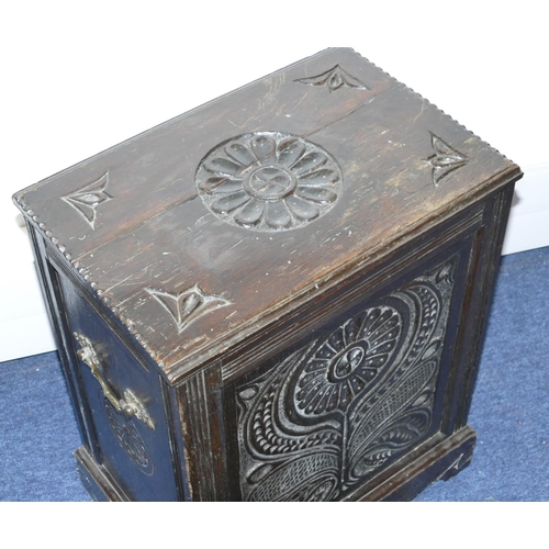 820 - A carved oak coal box with hinged lid with floral and leaf decoration, enclosing liner on bracket fe... 