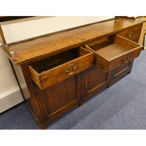 835 - A Georgian oak Welsh dresser with open shelf back, 3 drawers above single panel, flanked by 2 panel ... 