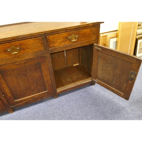 835 - A Georgian oak Welsh dresser with open shelf back, 3 drawers above single panel, flanked by 2 panel ... 