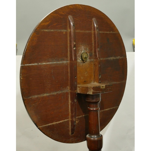 843 - A 19th Century oak round tilt top occasional table on gun barrel stem with 3 splayed legs, 78cm diam... 