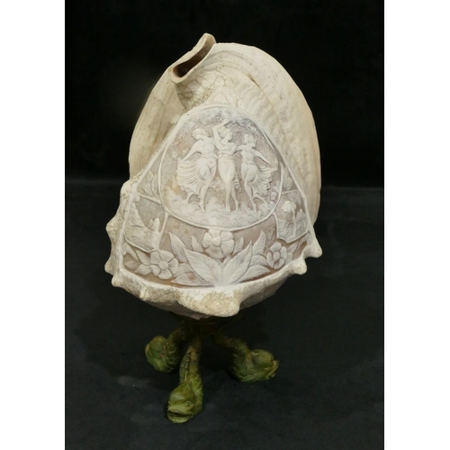 736 - A large conch shell converted to a lamp with carved figure, floral and leaf decoration on metal base... 