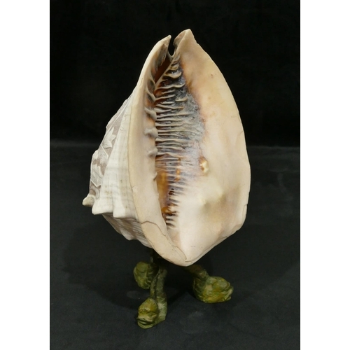 736 - A large conch shell converted to a lamp with carved figure, floral and leaf decoration on metal base... 