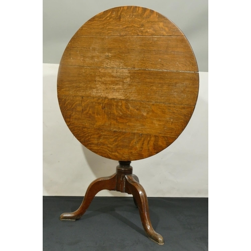 843 - A 19th Century oak round tilt top occasional table on gun barrel stem with 3 splayed legs, 78cm diam... 