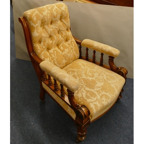 848 - A 19th Century mahogany armchair with cream and yellow floral overstuffed seat, button back and padd... 