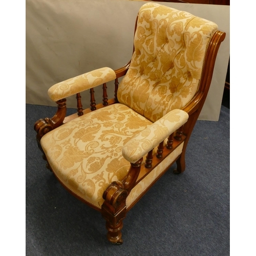 848 - A 19th Century mahogany armchair with cream and yellow floral overstuffed seat, button back and padd... 