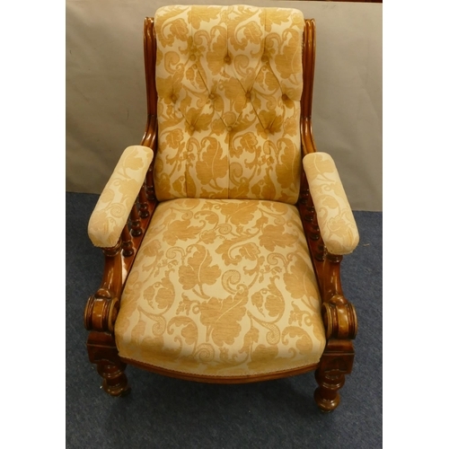 848 - A 19th Century mahogany armchair with cream and yellow floral overstuffed seat, button back and padd... 