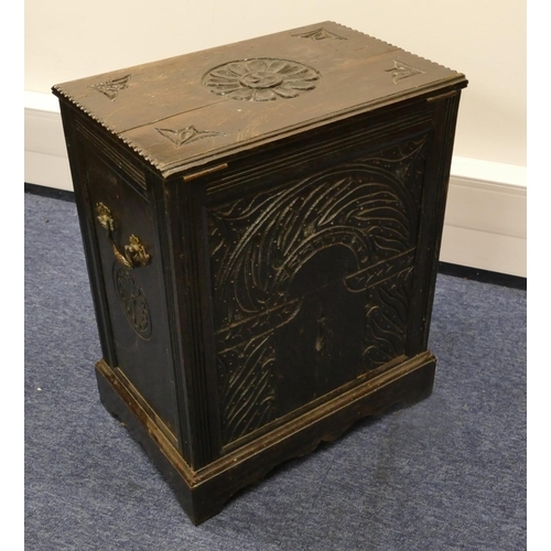 820 - A carved oak coal box with hinged lid with floral and leaf decoration, enclosing liner on bracket fe... 