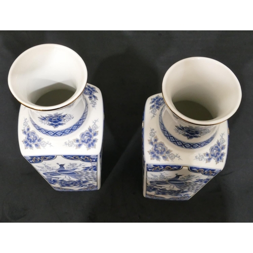 4083 - A pair of Oriental style vases on white ground with blue and gilt peacock, flower and leaf decoratio... 