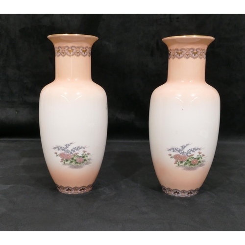 4086 - A pair of Japanese vases on white and peach ground with multi-coloured butterfly and flower decorati... 