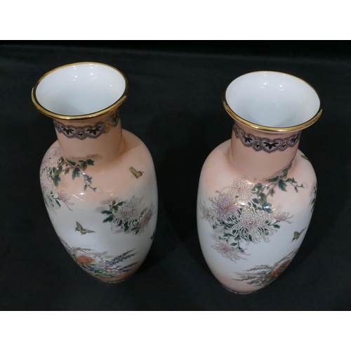 4086 - A pair of Japanese vases on white and peach ground with multi-coloured butterfly and flower decorati... 