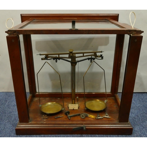 4114 - A set of brass balance scales in fitted mahogany cabinet, 48cm wide, 42cm high.