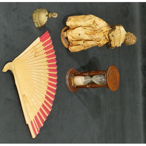 4139 - A Mahogany egg timer, 16cm high, a Continental doll, a brass bell in the form of a lady and a fan (4... 