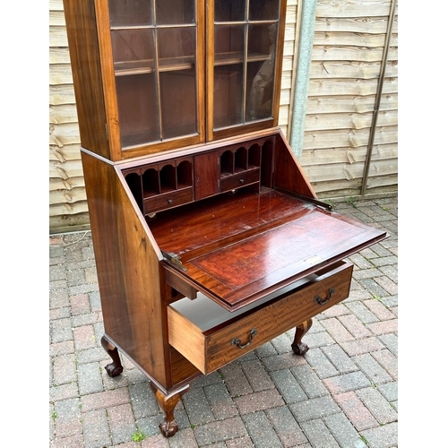 4143 - A 1930's mahogany bureau bookcase, 2 glass panelled doors above fall front, 3 drawers below on cabri... 