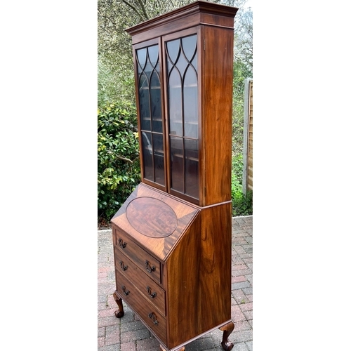 4143 - A 1930's mahogany bureau bookcase, 2 glass panelled doors above fall front, 3 drawers below on cabri... 