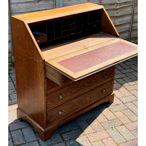 4145 - A good quality oak bureau, fall front above 2 short and 3 long drawers with drop brass handles on br... 