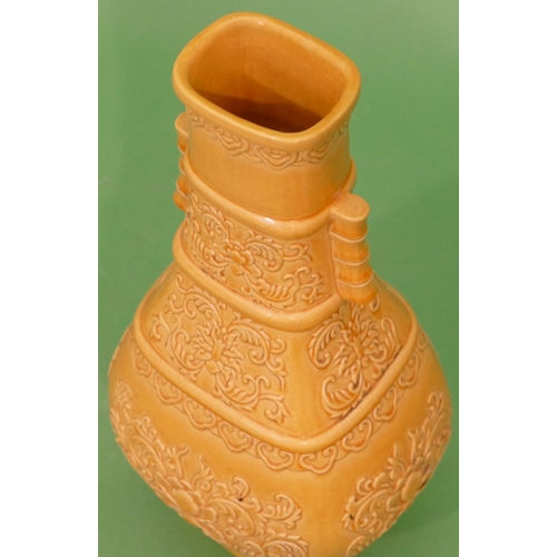 61 - An Oriental rectangular bulbous thin necked 2- handled vase on yellow ground with raised floral and ... 