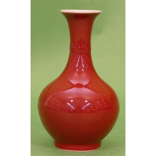 69 - An Oriental small round bulbous thin necked trumpet shaped vase on red ground, 15cm high.