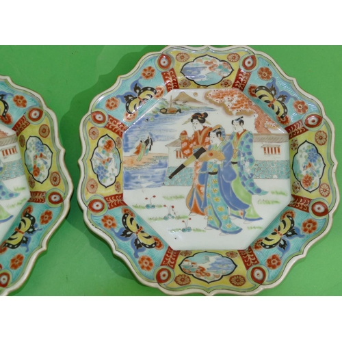 97 - A pair of Oriental scallop shaped plates with multi-coloured figure, butterfly, floral, leaf and scr... 