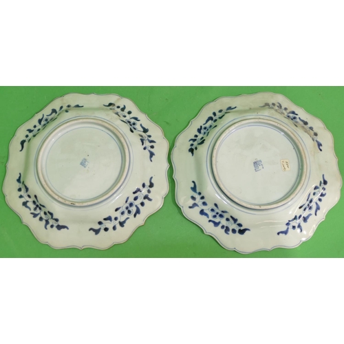 97 - A pair of Oriental scallop shaped plates with multi-coloured figure, butterfly, floral, leaf and scr... 