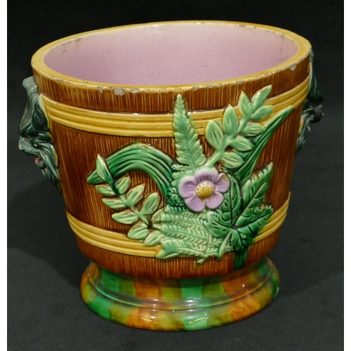 100 - A Majolica round 2-handled trumpet shaped jardiniere on brown, green and pink ground with raised mas... 